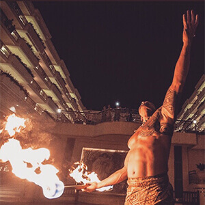 fire knife dancer performing in front of hawaii hotel