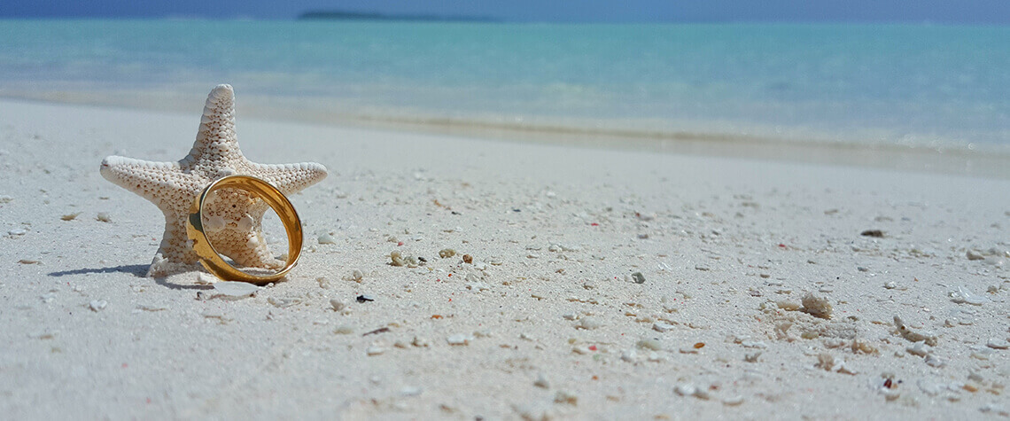 wedding band with starfish on beach