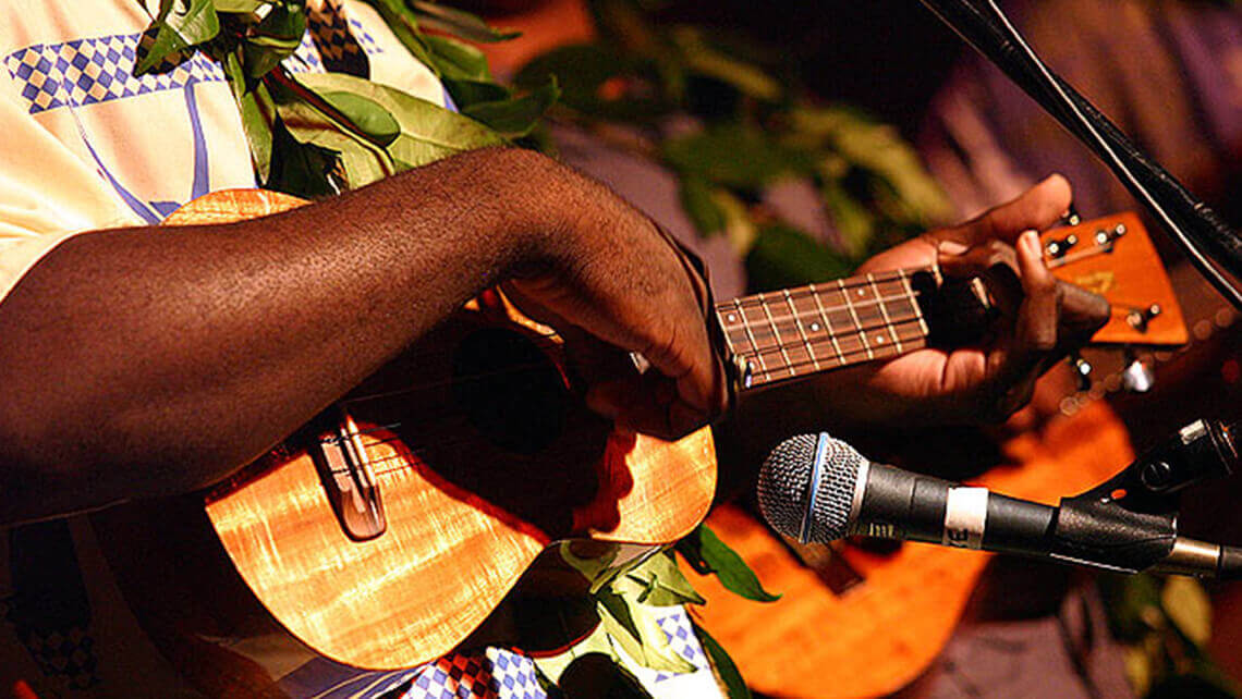 hawaiian musicians in matching aloha shirt