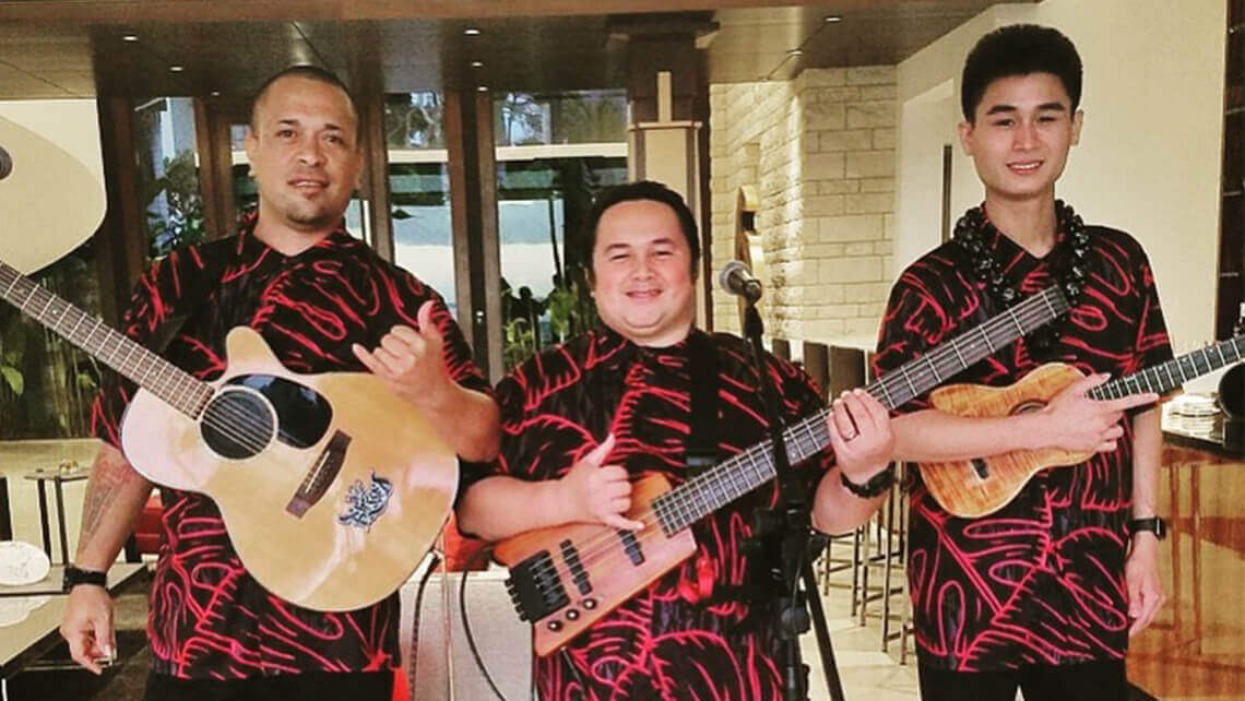 hawaiian musicians in matching aloha shirt