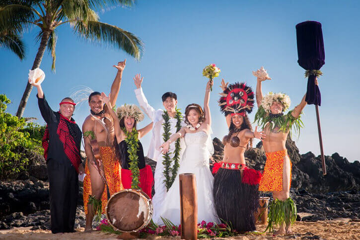 wedding couple on beach with hawaiian musician with ukulele