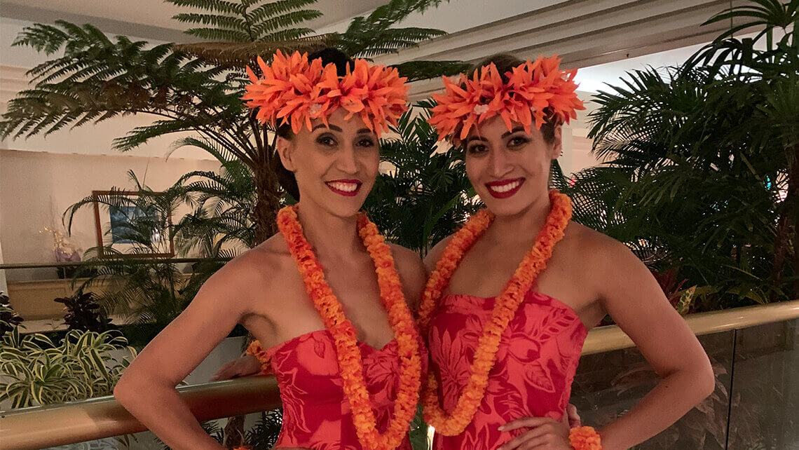 two hula dancers in costumes