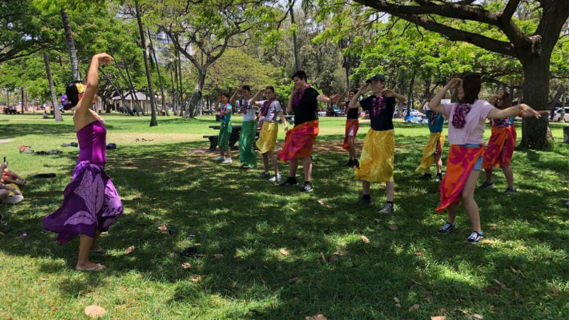 group learning how to hula in hawaii