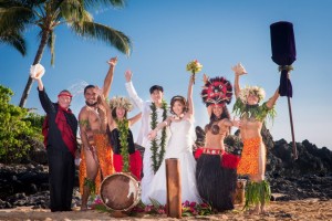wedding photo on beach with hula dancers